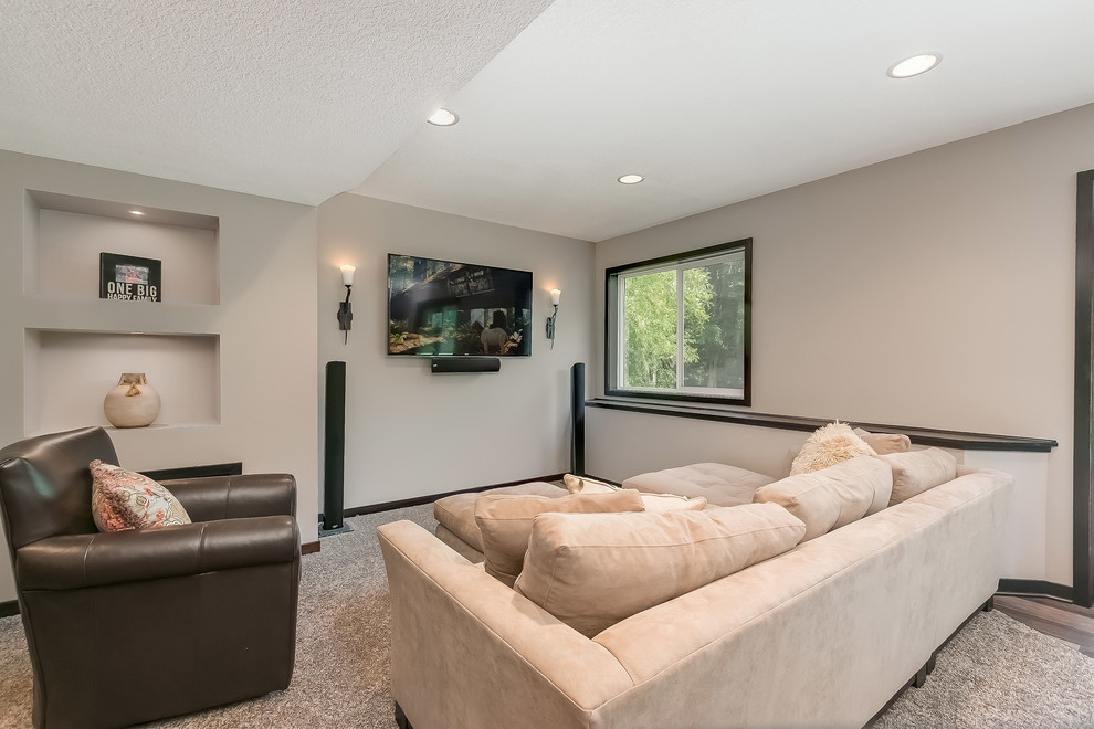 Inspiration for a large transitional walk-out basement in Minneapolis with carpet, grey walls, a ribbon fireplace, a metal fireplace surround and beige floor.