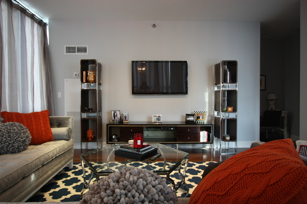 Photo of a mid-sized contemporary open concept living room in Chicago with grey walls, medium hardwood floors and a wall-mounted tv.