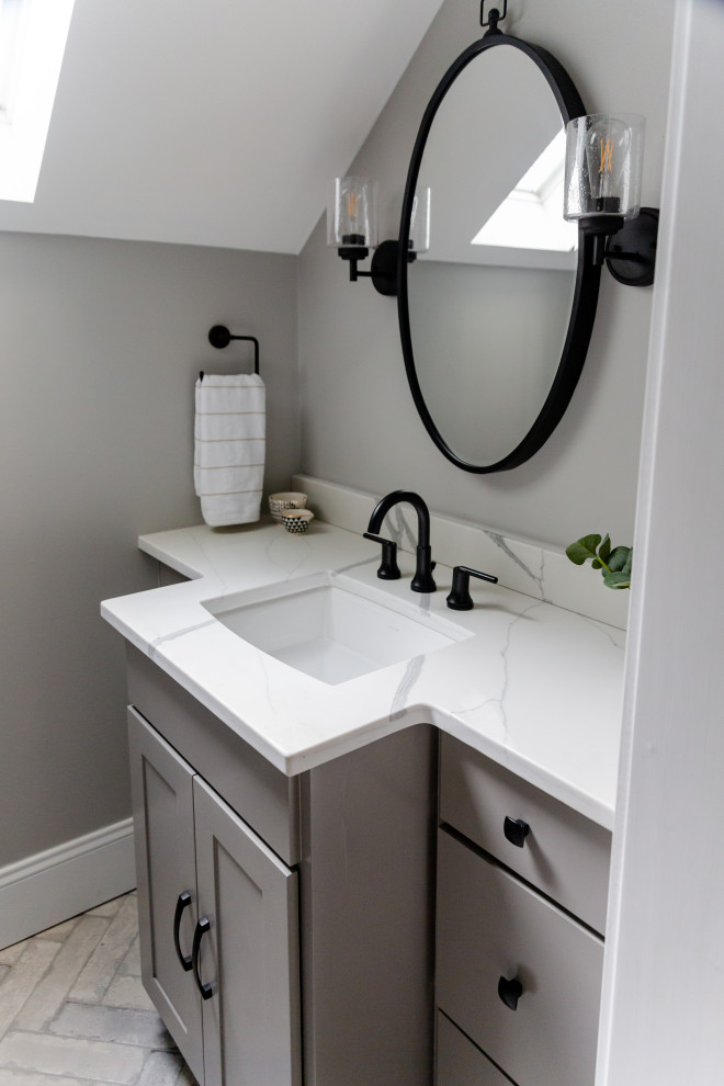 Photo of a small transitional wet room bathroom in Charleston with flat-panel cabinets, grey cabinets, a two-piece toilet, gray tile, porcelain tile, grey walls, porcelain floors, an undermount sink, engineered quartz benchtops, grey floor, an open shower, white benchtops, a niche, a single vanity, a built-in vanity and vaulted.