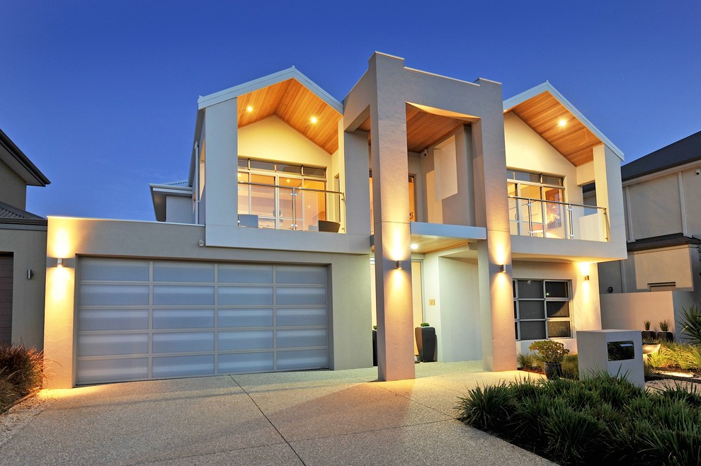 Photo of a large contemporary two-storey stucco white exterior in Perth with a hip roof.
