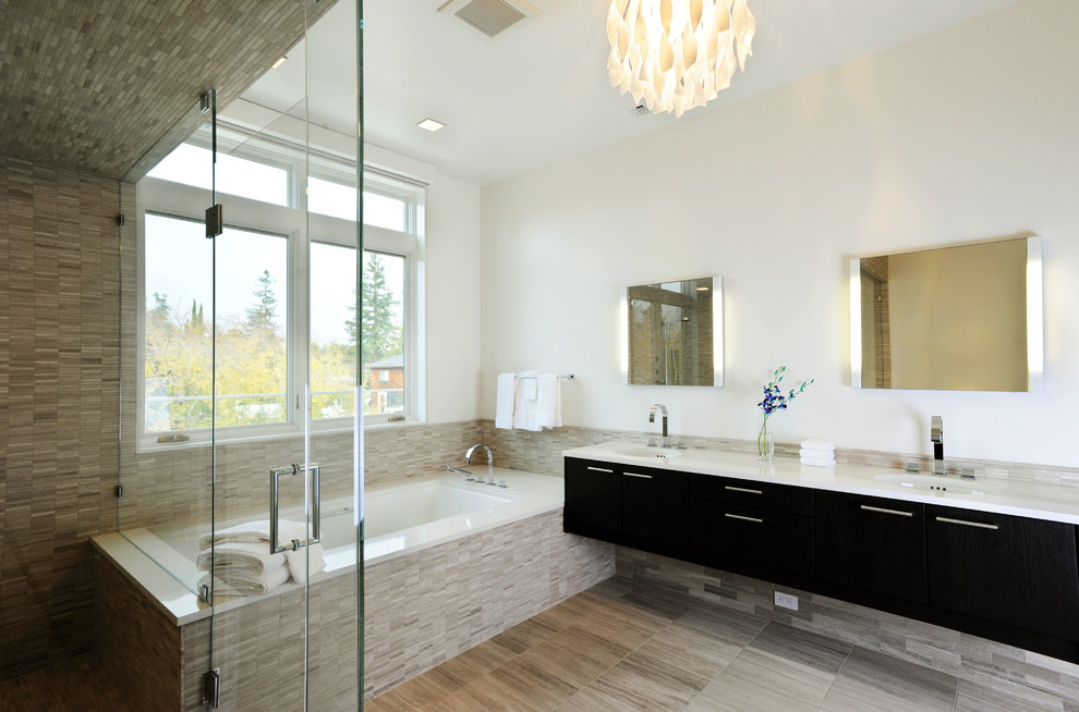 This is an example of a large contemporary master bathroom in San Francisco with flat-panel cabinets, black cabinets, a corner shower, a two-piece toilet, beige tile, stone tile, white walls, porcelain floors, an undermount sink, engineered quartz benchtops and an undermount tub.