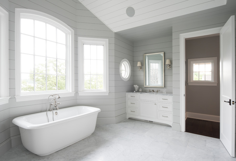 Design ideas for a mid-sized transitional master bathroom in Minneapolis with open cabinets, dark wood cabinets, a freestanding tub, white walls, marble floors, an undermount sink, wood benchtops and red floor.