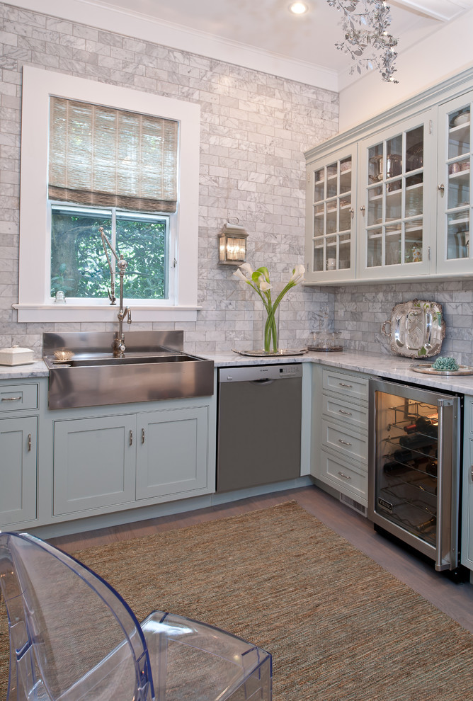 This is an example of a mid-sized traditional l-shaped separate kitchen in New York with a farmhouse sink, beaded inset cabinets, blue cabinets, marble benchtops, stainless steel appliances, grey splashback, light hardwood floors, no island and marble splashback.