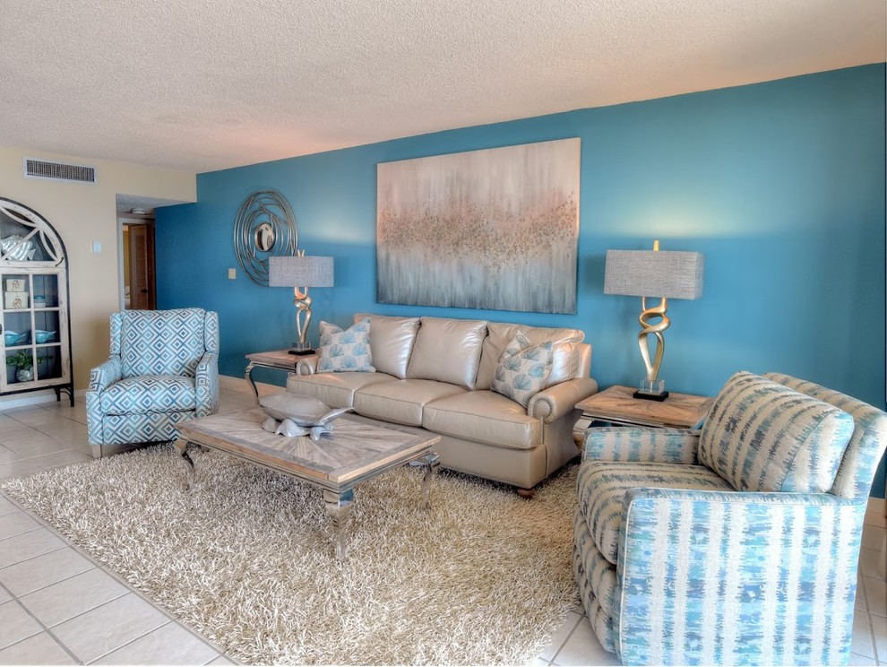 This is an example of a mid-sized transitional open concept living room in Miami with blue walls, ceramic floors and no fireplace.