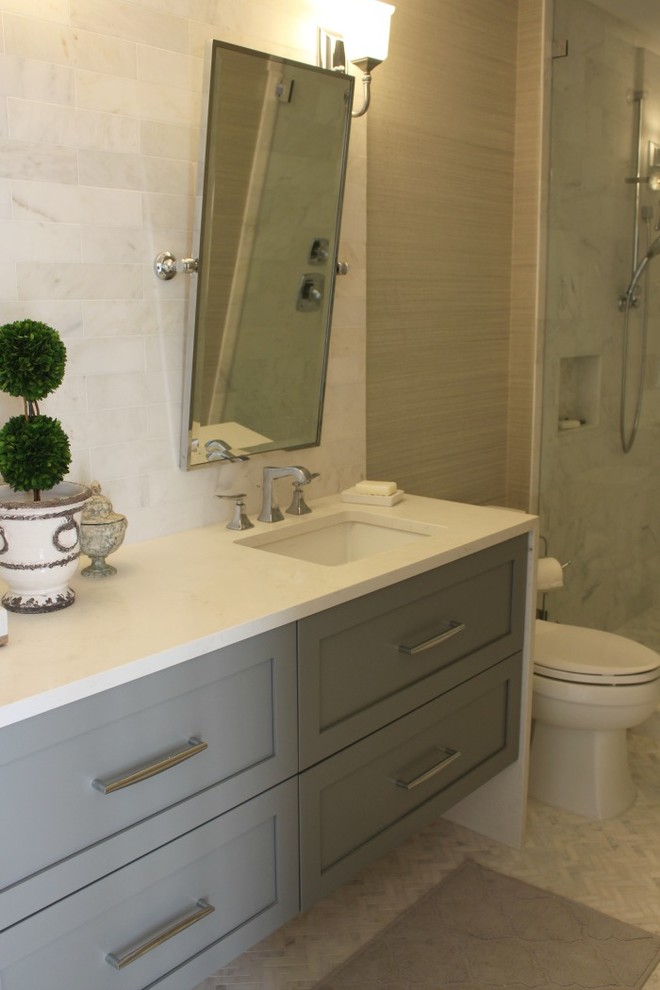 Photo of a mid-sized transitional bathroom in Tampa with shaker cabinets, grey cabinets, a two-piece toilet, gray tile, marble, grey walls, marble floors, an undermount sink, quartzite benchtops and grey floor.