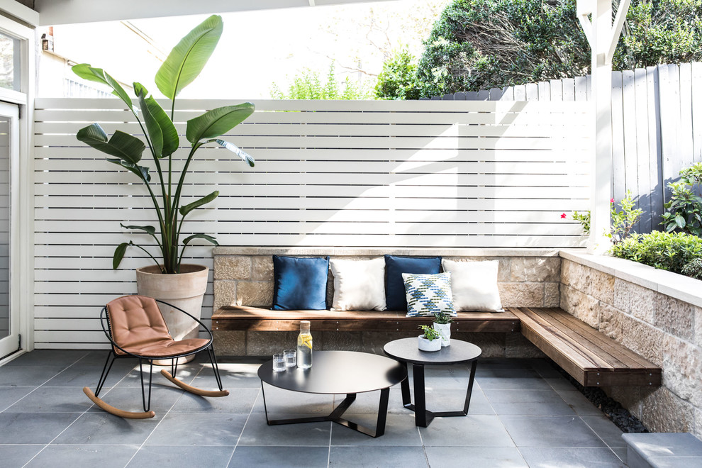 Photo of a mid-sized contemporary backyard patio in Sydney with tile.