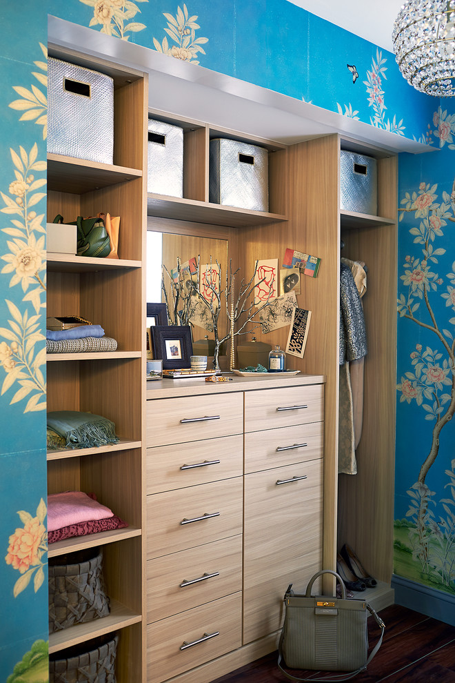 This is an example of a small contemporary gender-neutral dressing room in New York with flat-panel cabinets and light wood cabinets.