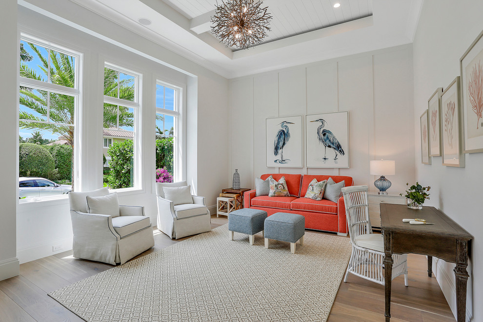 Inspiration for a beach style family room in Miami with white walls, medium hardwood floors and brown floor.