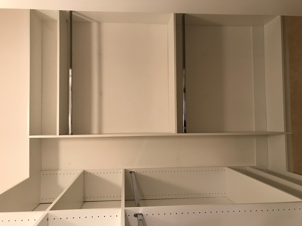 Reach-in closet - small transitional gender-neutral brown floor and carpeted reach-in closet idea in Louisville with open cabinets and white cabinets