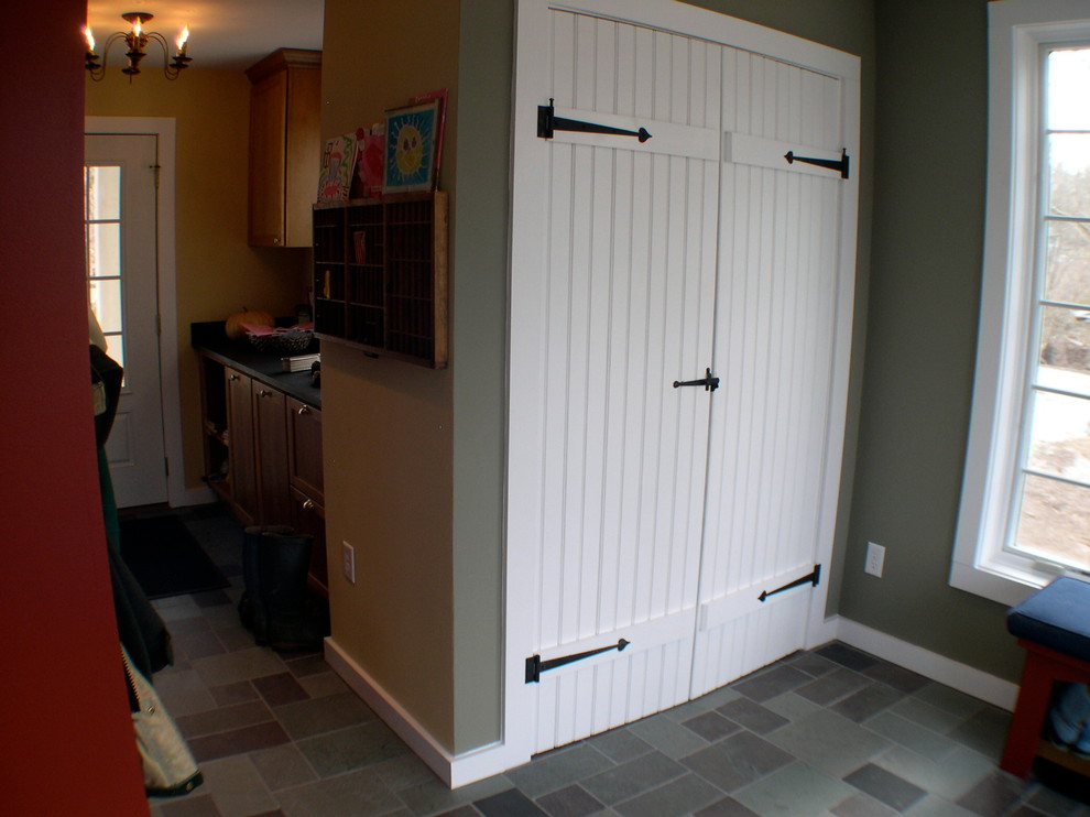 Photo of a small country mudroom in Philadelphia with slate floors.