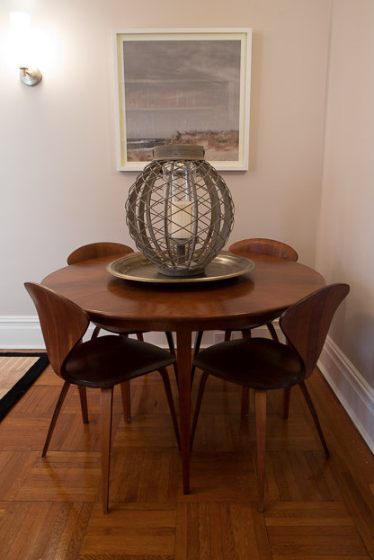 Small contemporary separate dining room in New York with grey walls and medium hardwood floors.