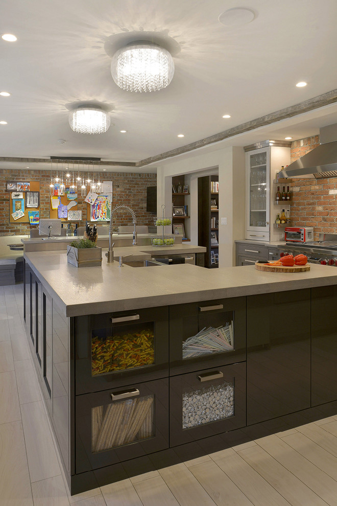 Photo of a large modern u-shaped eat-in kitchen in New York with a farmhouse sink, glass-front cabinets, grey cabinets, granite benchtops, stainless steel appliances, light hardwood floors and multiple islands.