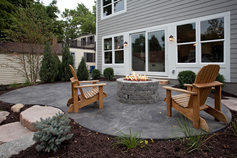 Inspiration for a large traditional patio in Minneapolis with a fire feature, no cover and stamped concrete.