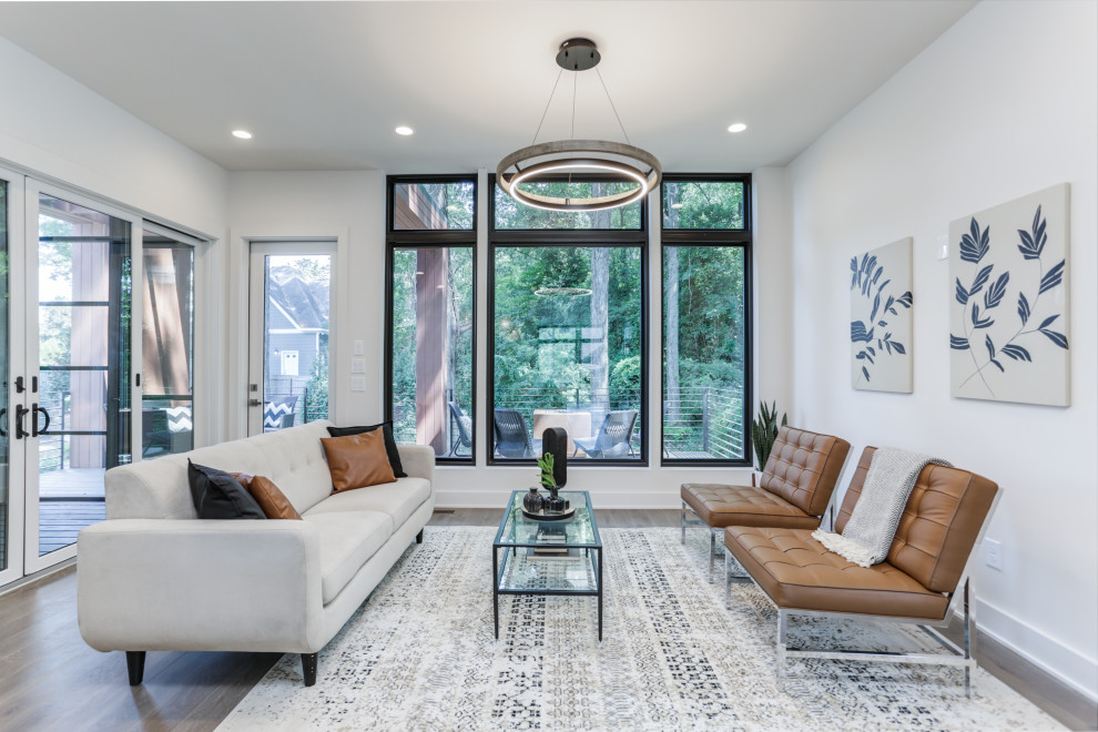 Photo of a contemporary living room in Atlanta with white walls, dark hardwood floors and brown floor.