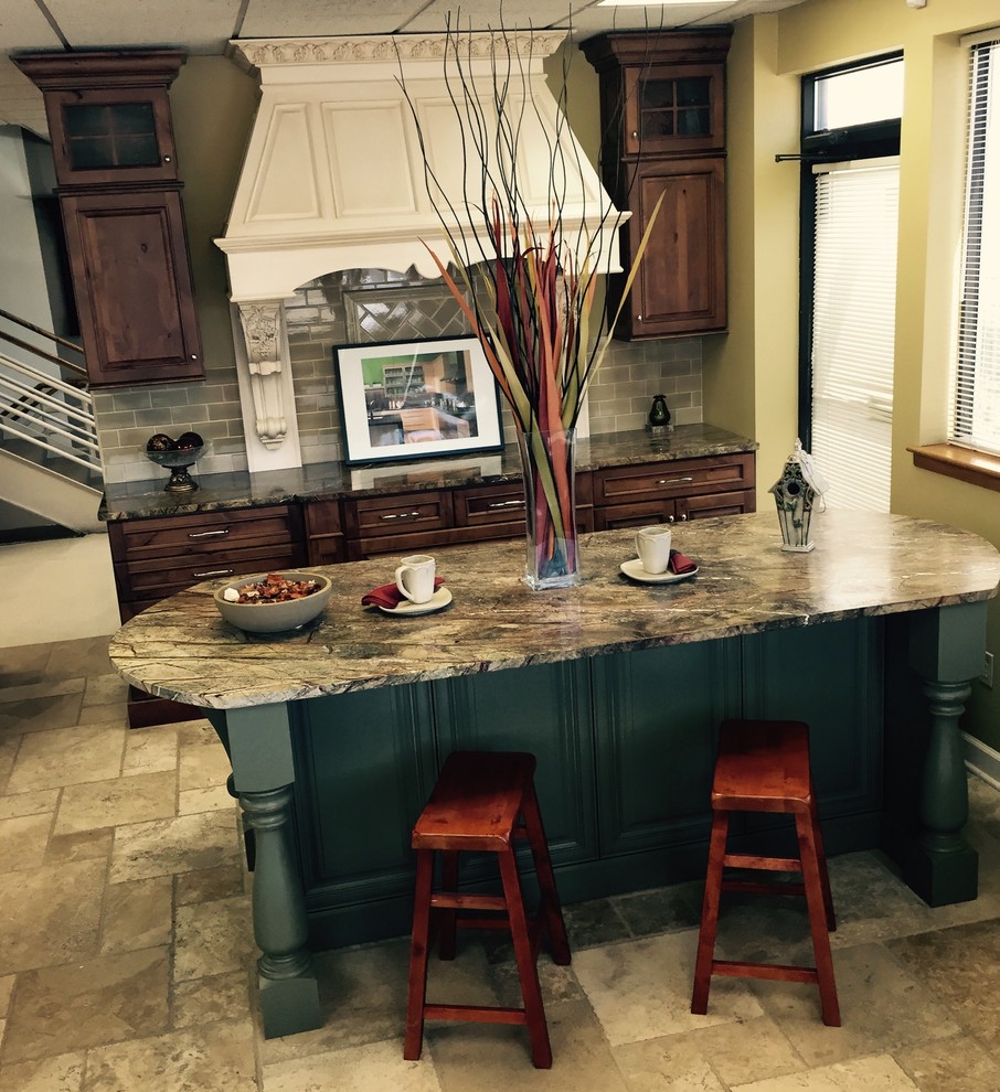 Photo of a traditional eat-in kitchen in Chicago with brown cabinets, green splashback and with island.