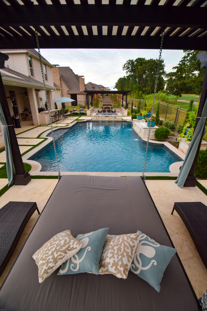 Design ideas for a mid-sized contemporary backyard custom-shaped lap pool in Dallas with a water feature and natural stone pavers.
