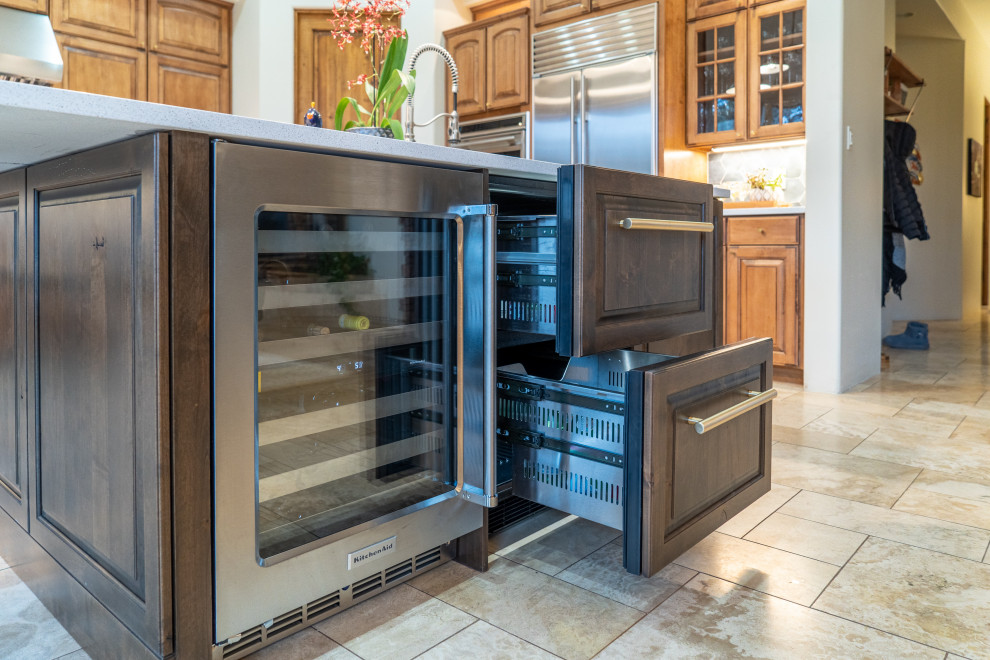 Kitchen photo in Phoenix with raised-panel cabinets, medium tone wood cabinets and an island