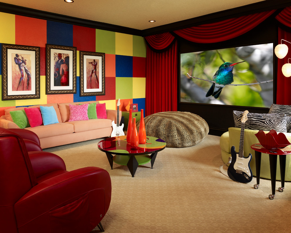 This is an example of a large open concept home theatre in Orlando with multi-coloured walls, carpet, a projector screen and red floor.
