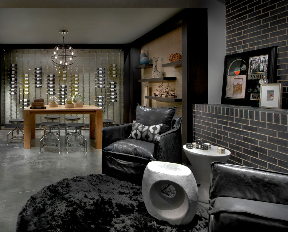 This is an example of a contemporary wine cellar in Chicago with display racks and grey floor.