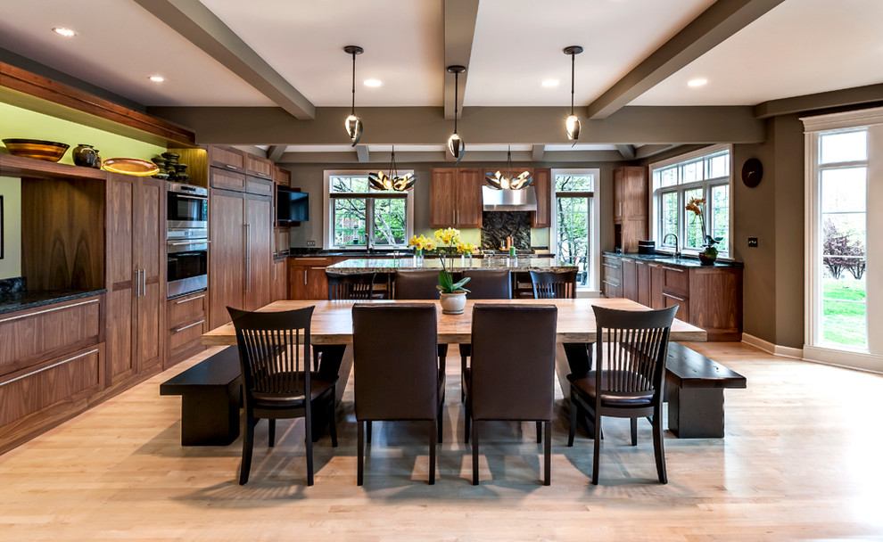 Example of a huge transitional u-shaped light wood floor eat-in kitchen design in Chicago with an undermount sink, recessed-panel cabinets, medium tone wood cabinets, granite countertops, stainless steel appliances, an island, green backsplash and stone slab backsplash