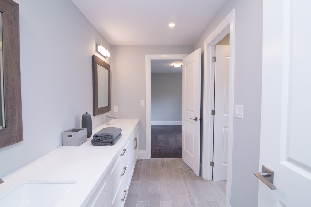 Inspiration for a mid-sized arts and crafts kids bathroom in Toronto with shaker cabinets, white cabinets, a freestanding tub, an open shower, a one-piece toilet, white tile, stone tile, beige walls, ceramic floors, an undermount sink, engineered quartz benchtops, beige floor and a hinged shower door.