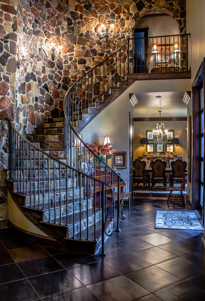 Photo of a traditional wood curved staircase in Austin.