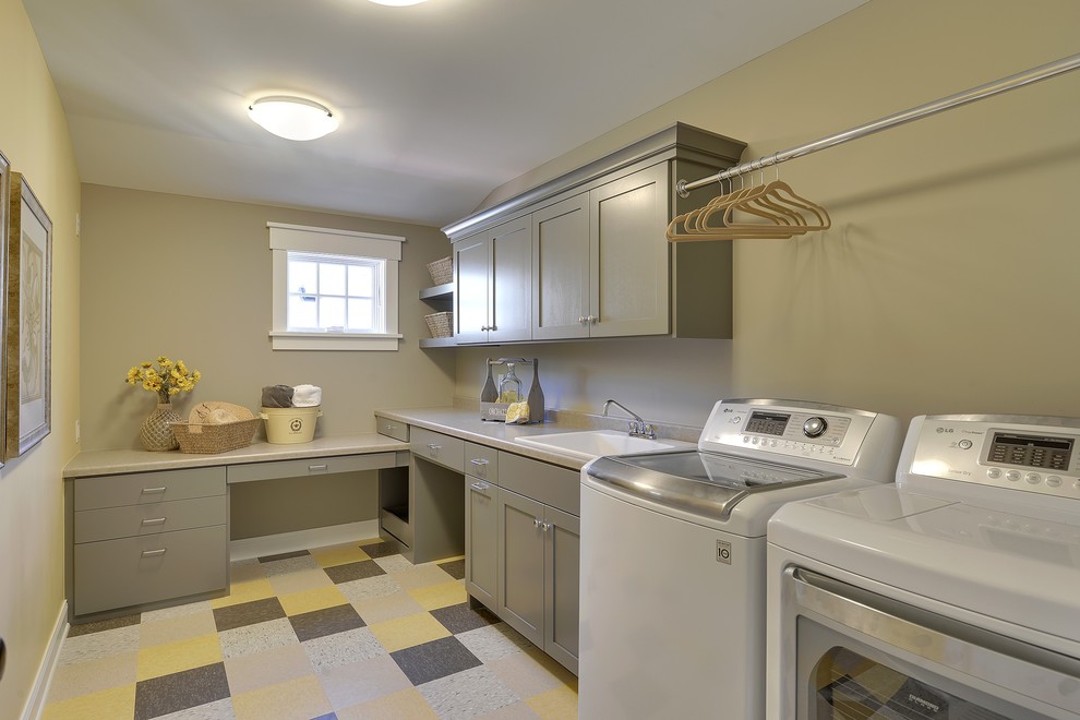 Traditional laundry room in Minneapolis with a drop-in sink and multi-coloured floor.