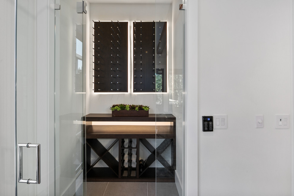 Design ideas for a mid-sized country wine cellar in Seattle with ceramic floors, storage racks and grey floor.