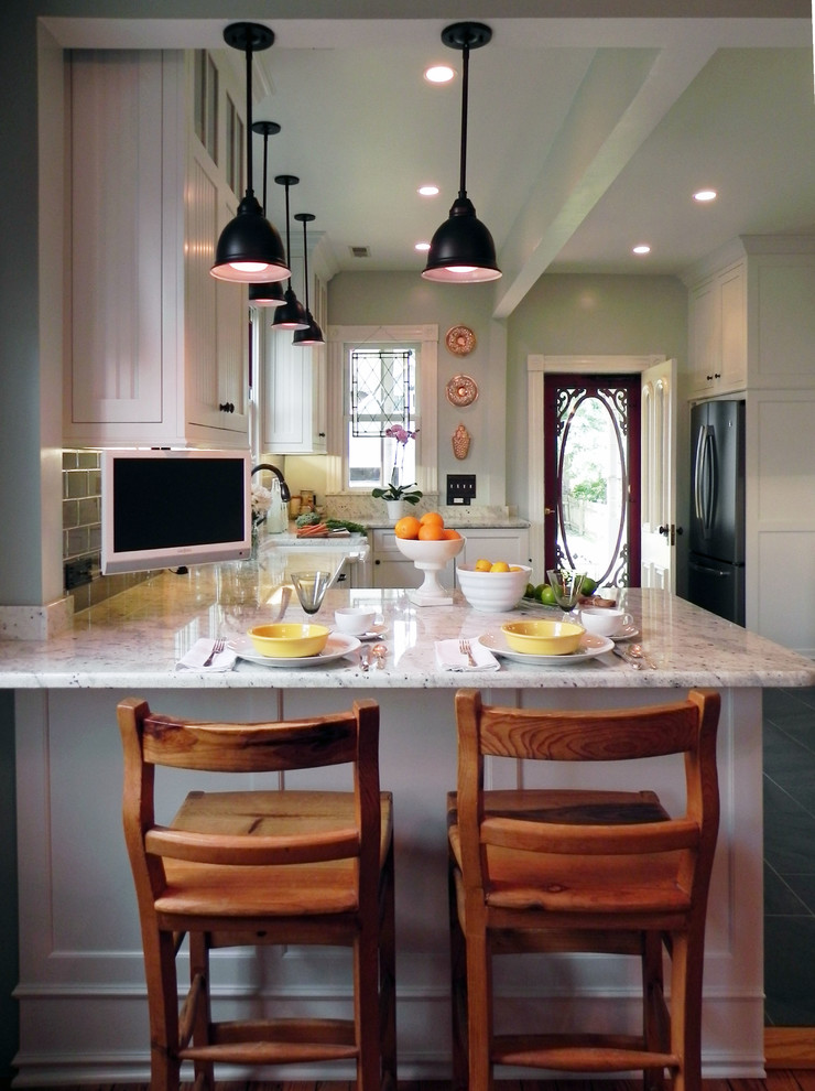 Design ideas for a mid-sized country u-shaped eat-in kitchen in Baltimore with a farmhouse sink, shaker cabinets, white cabinets, marble benchtops, grey splashback, subway tile splashback, stainless steel appliances, slate floors, no island and brown floor.