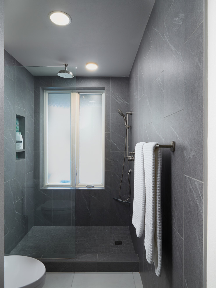 This is an example of a mid-sized contemporary master bathroom in Portland with flat-panel cabinets, dark wood cabinets, an alcove shower, a two-piece toilet, blue tile, glass tile, white walls, porcelain floors, an undermount sink, engineered quartz benchtops, white floor, a hinged shower door and white benchtops.