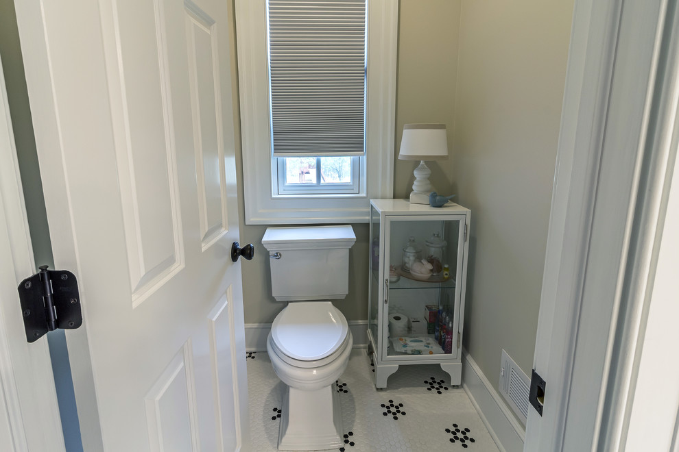 Corner shower - mid-sized transitional master gray tile and subway tile ceramic tile and white floor corner shower idea with raised-panel cabinets, gray cabinets, an undermount tub, a two-piece toilet, beige walls, an undermount sink, marble countertops and a hinged shower door