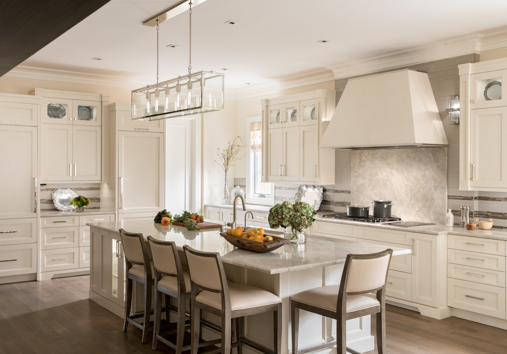 Photo of a transitional l-shaped kitchen in Denver with recessed-panel cabinets, white cabinets, grey splashback, panelled appliances, dark hardwood floors and with island.