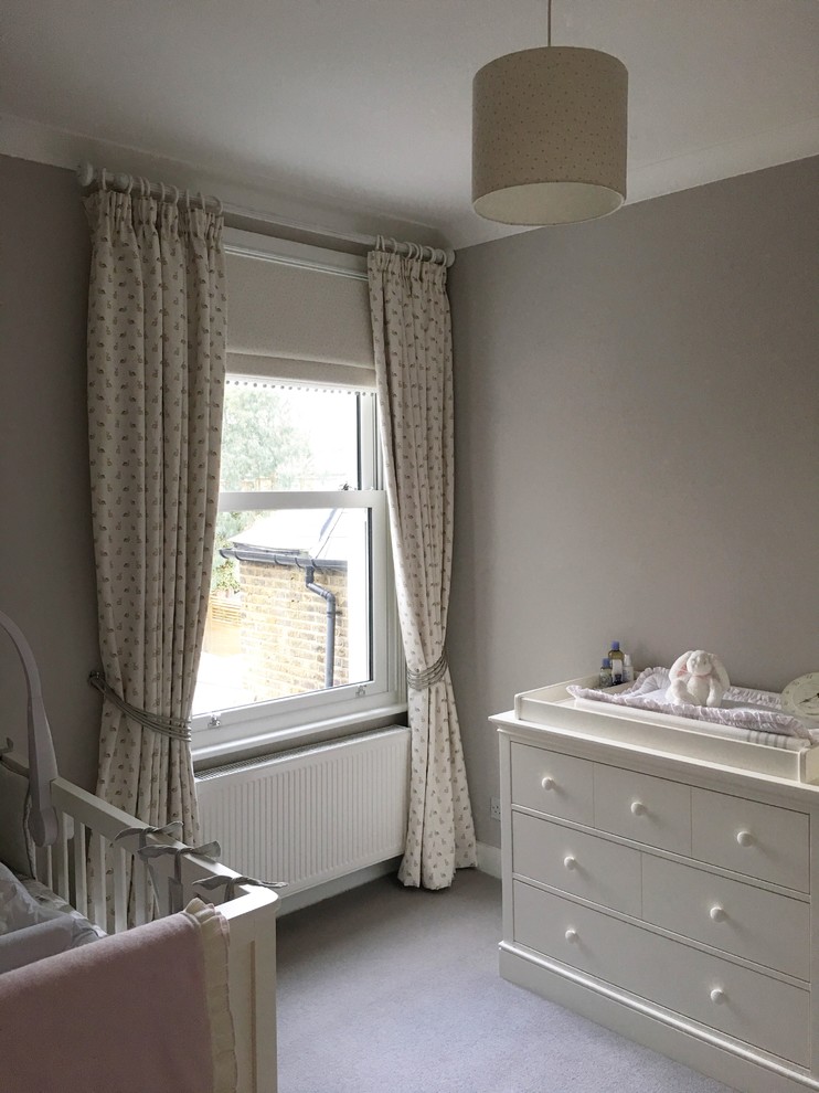 Design ideas for a country gender-neutral nursery in London with grey walls and carpet.