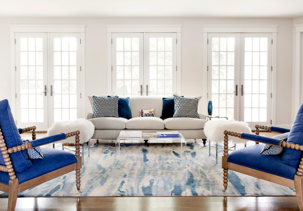 Photo of a transitional formal open concept living room in New York with white walls and medium hardwood floors.
