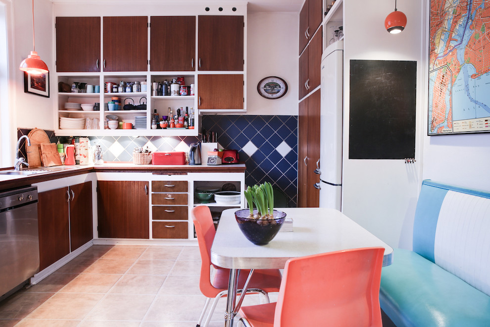 This is an example of a midcentury l-shaped eat-in kitchen in Copenhagen with flat-panel cabinets, dark wood cabinets, multi-coloured splashback, stainless steel appliances and no island.