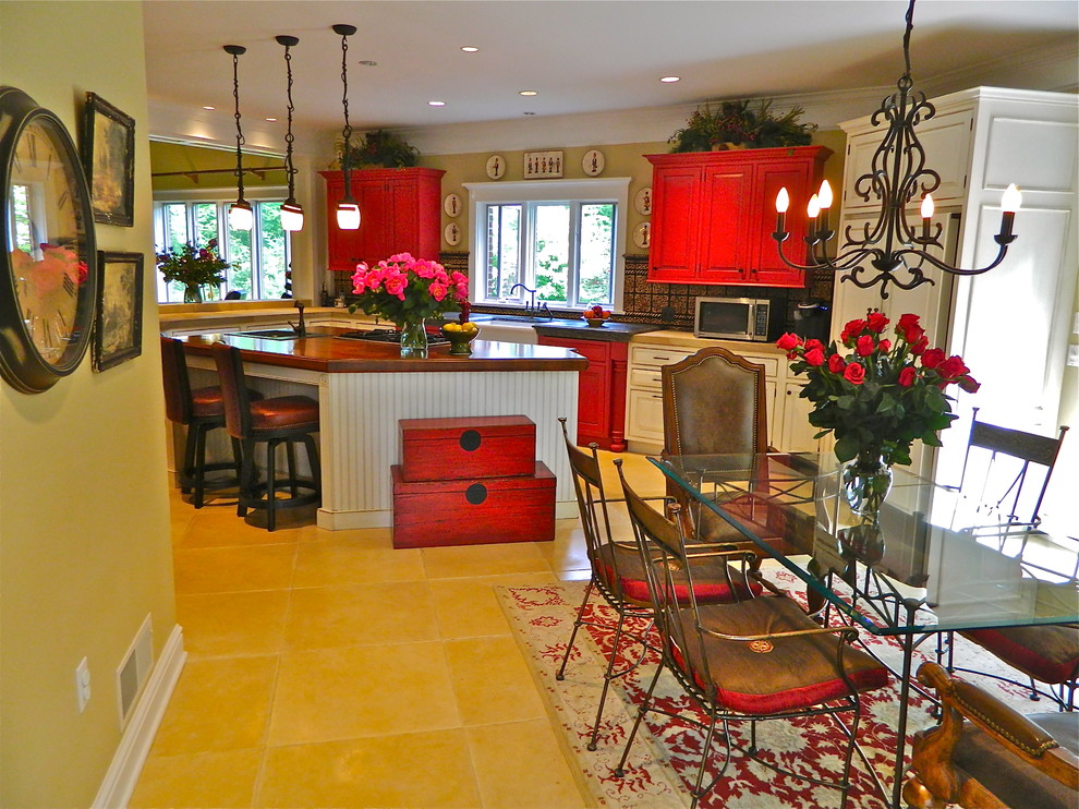 Eat-in kitchen - large rustic l-shaped limestone floor eat-in kitchen idea with an island, beaded inset cabinets, red cabinets, soapstone countertops, multicolored backsplash, terra-cotta backsplash, paneled appliances and a farmhouse sink