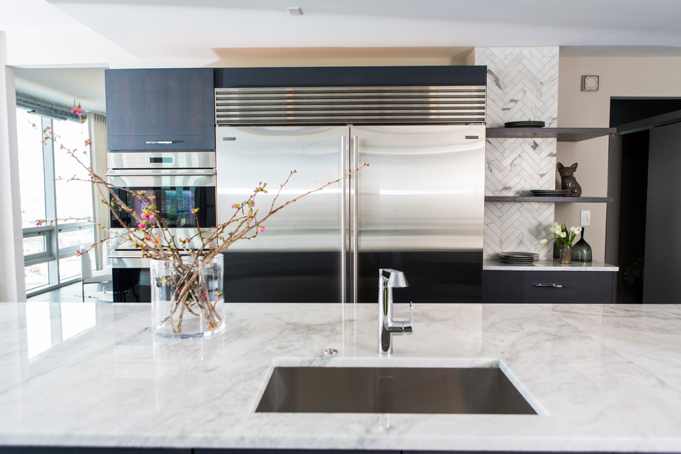 Inspiration for an expansive contemporary u-shaped eat-in kitchen in Baltimore with an undermount sink, flat-panel cabinets, grey cabinets, marble benchtops, white splashback, stainless steel appliances, dark hardwood floors, with island, marble splashback and grey floor.