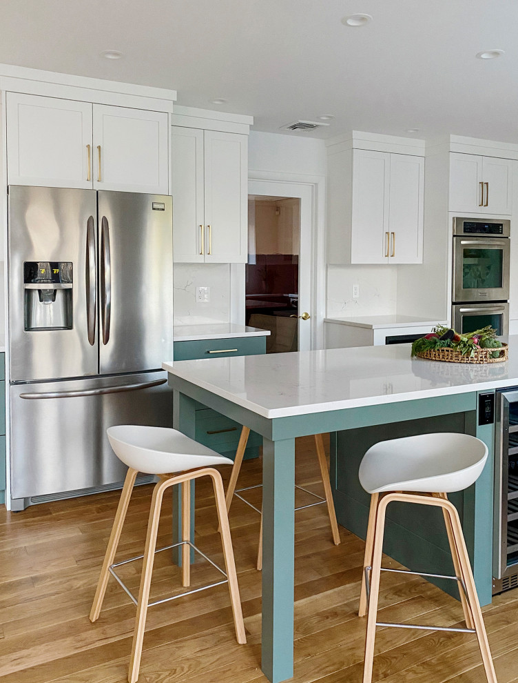 Mid-sized 1950s u-shaped light wood floor and beige floor eat-in kitchen photo in New York with a farmhouse sink, shaker cabinets, green cabinets, multicolored backsplash, mosaic tile backsplash, stainless steel appliances, an island and white countertops