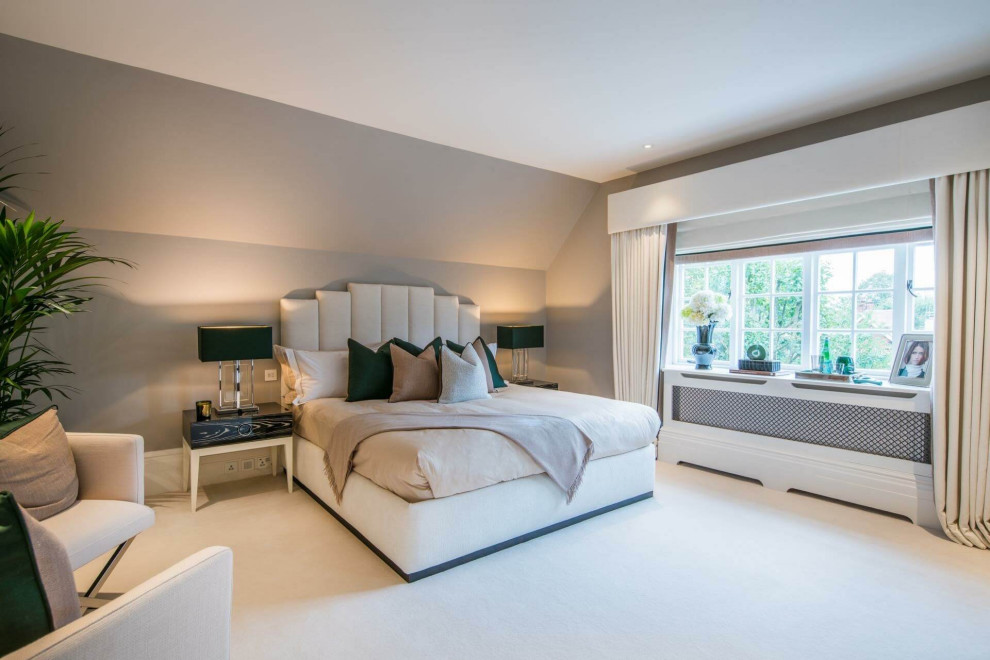 Inspiration for a small contemporary master bedroom in London with beige walls, carpet and beige floor.