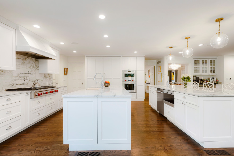 Inspiration for an expansive traditional l-shaped open plan kitchen in Denver with a submerged sink, shaker cabinets, white cabinets, stainless steel appliances, multiple islands and a vaulted ceiling.