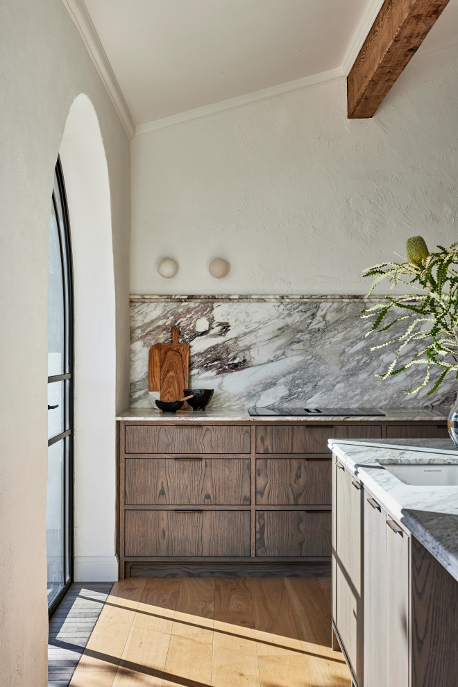 Eat-in kitchen - large transitional galley light wood floor, brown floor and exposed beam eat-in kitchen idea in Sydney with a single-bowl sink, flat-panel cabinets, dark wood cabinets, marble countertops, multicolored backsplash, marble backsplash, black appliances, an island and multicolored countertops