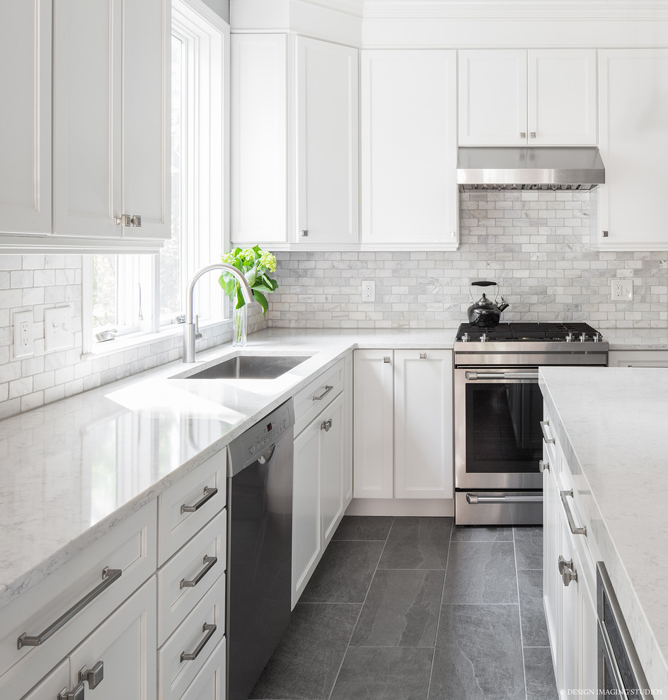 Inspiration for a large transitional open plan kitchen in Boston with an undermount sink, white cabinets, quartzite benchtops, white splashback, marble splashback, stainless steel appliances, slate floors, with island, grey floor and recessed-panel cabinets.