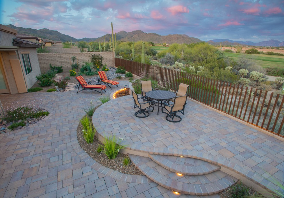 Design ideas for a mid-sized backyard patio in Phoenix with a fire feature, brick pavers and no cover.