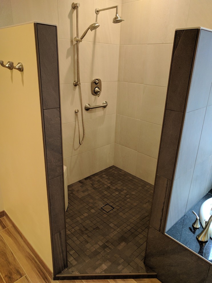 Inspiration for a mid-sized transitional master bathroom in Seattle with a drop-in tub, a corner shower, gray tile, porcelain tile, yellow walls, porcelain floors, brown floor and an open shower.