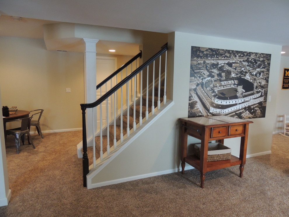 Inspiration for a mid-sized traditional look-out basement in Detroit with beige walls, carpet and no fireplace.