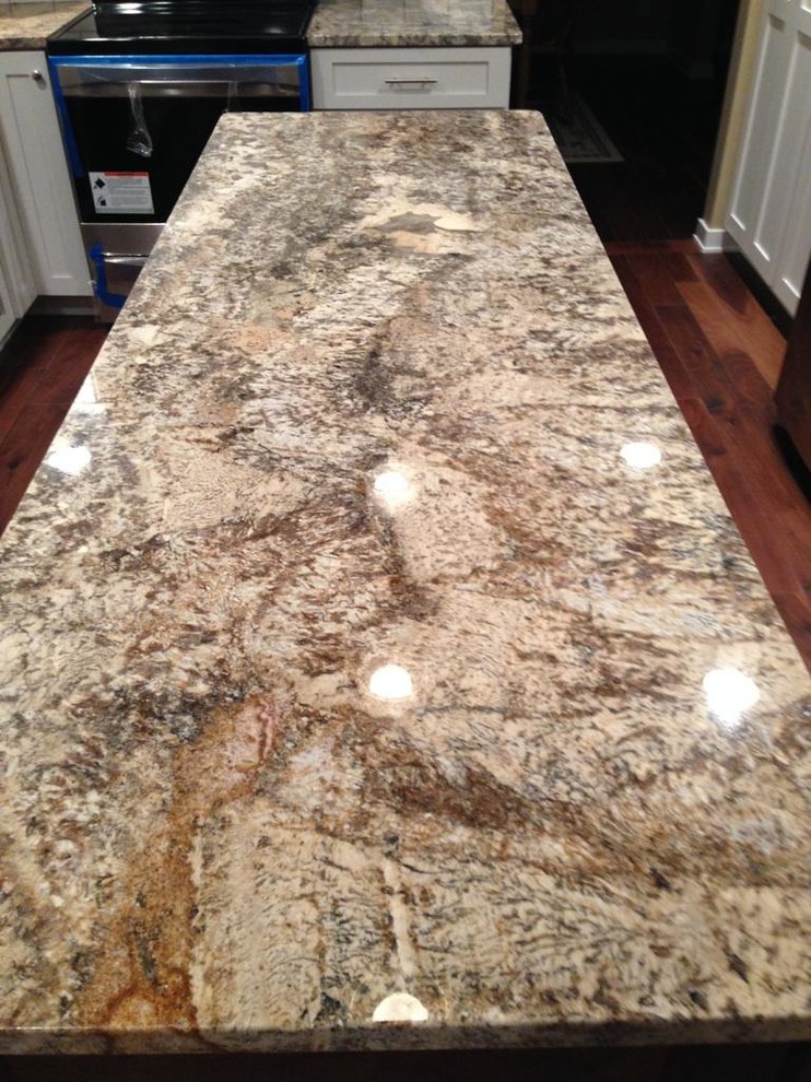Inspiration for a medium tone wood floor kitchen remodel with granite countertops, shaker cabinets, white cabinets, stainless steel appliances and an island