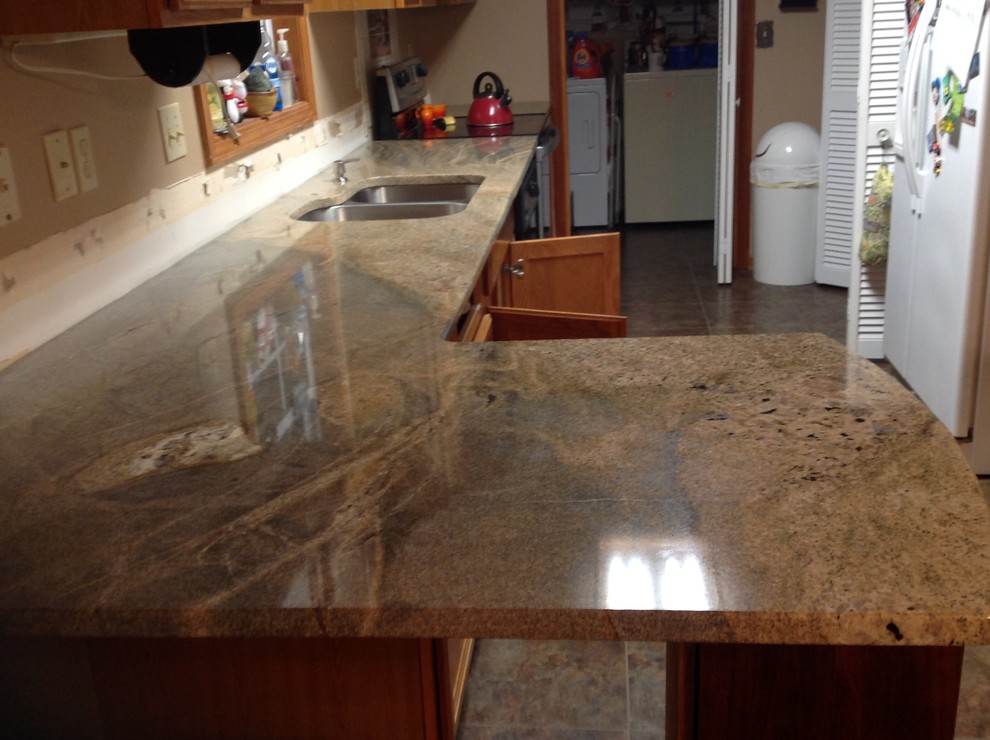 Inspiration for a l-shaped eat-in kitchen remodel with flat-panel cabinets and a peninsula