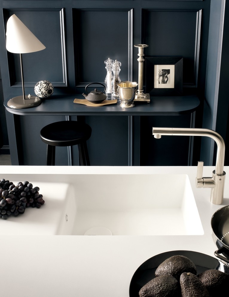 Design ideas for a contemporary kitchen in Other with an integrated sink, solid surface benchtops and with island.