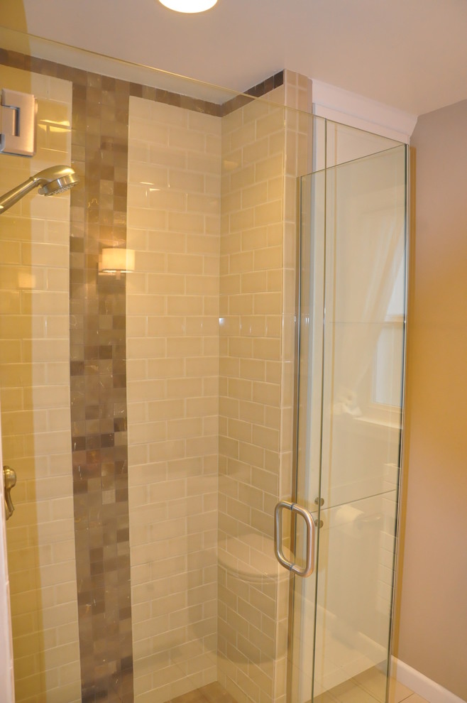 Small transitional 3/4 beige tile and ceramic tile porcelain tile corner shower photo in Seattle with an undermount sink, recessed-panel cabinets, white cabinets, quartzite countertops, a two-piece toilet and brown walls