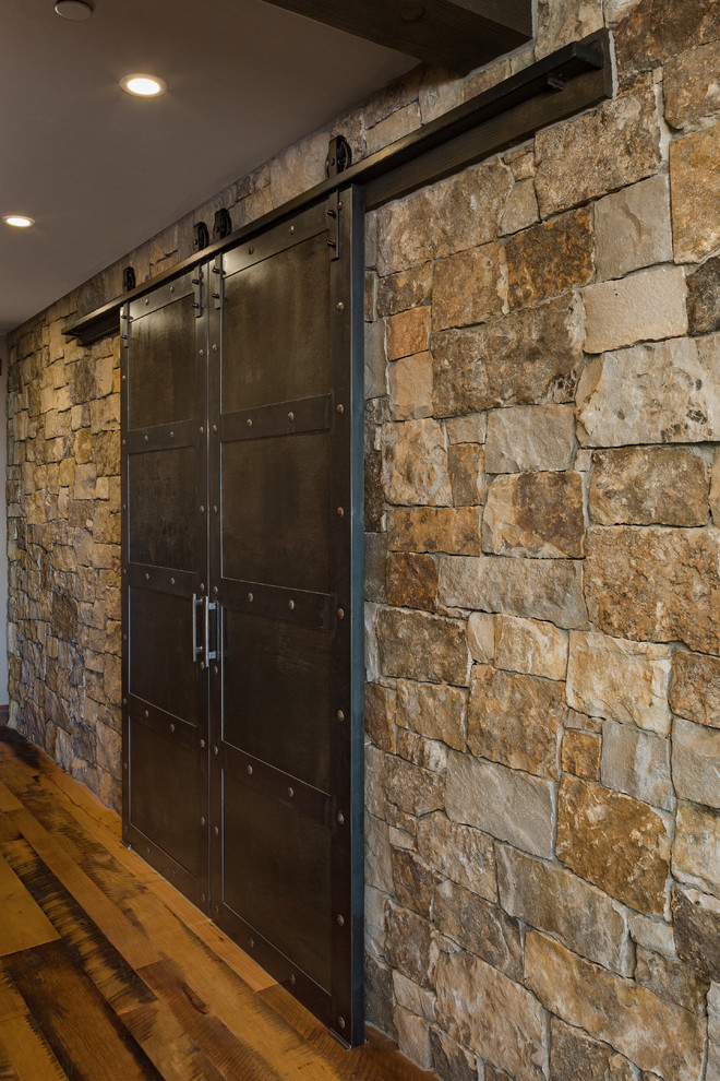 Example of a mountain style medium tone wood floor and brown floor hallway design
